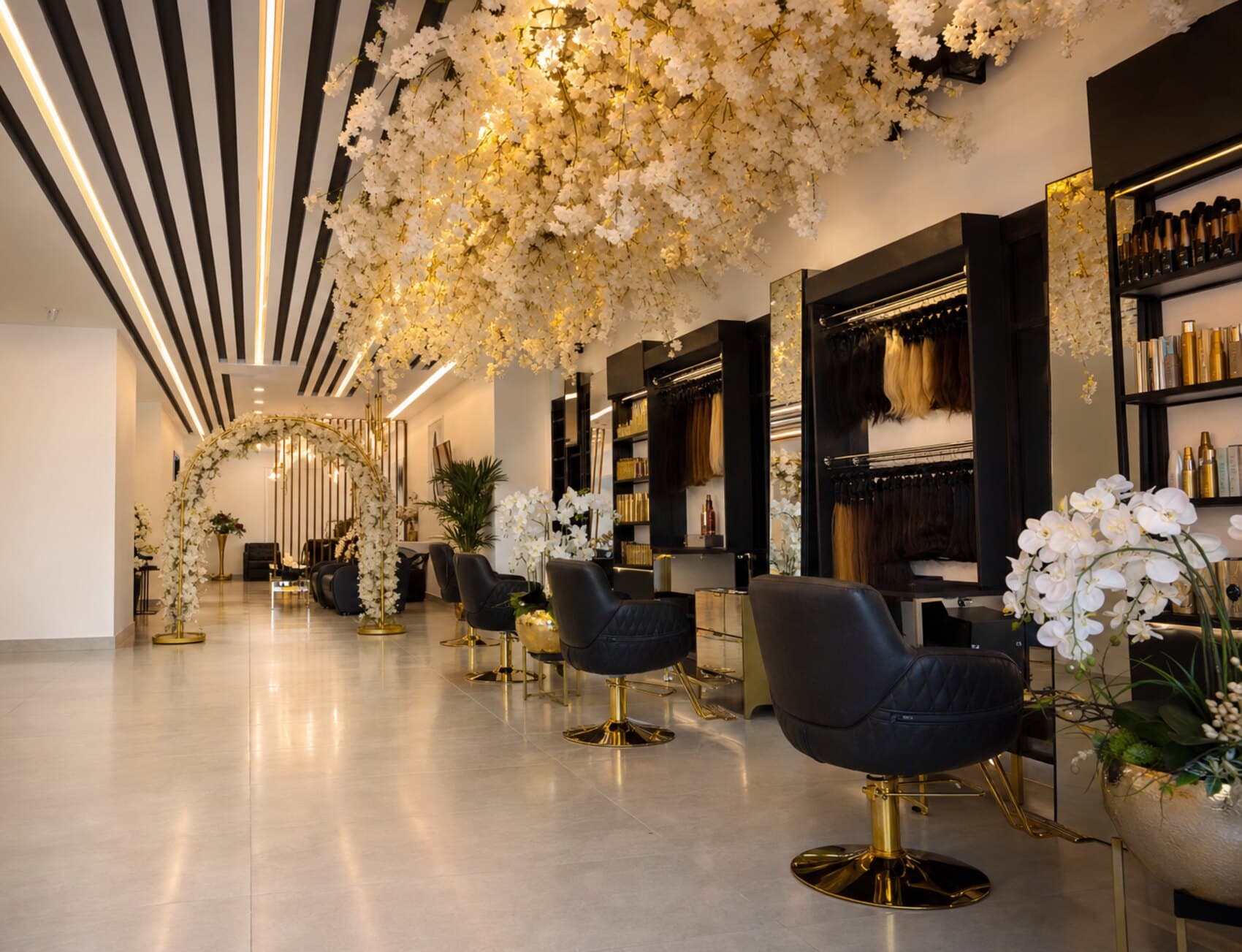 Qasr Alshar Salon — luxury interior with cascading floral ceiling and gold-accented styling chairs, Union Metro, Dubai